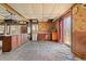 Dated kitchen with wood cabinets, vinyl flooring needing repair, and appliances at 90 Little Indian Creek Rd, Goldston, NC 27252