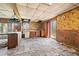 Dated kitchen with wood cabinets, vinyl flooring needing repair, and appliances at 90 Little Indian Creek Rd, Goldston, NC 27252