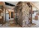 Rustic interior with exposed stone fireplace and unfinished flooring at 90 Little Indian Creek Rd, Goldston, NC 27252