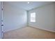 Spacious bedroom with neutral carpeting and large window at 1108 Middlecrest Dr, Rocky Mount, NC 27804