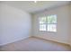 Bright bedroom with neutral walls, carpet flooring, and a large window at 1117 Middlecrest Dr, Rocky Mount, NC 27804