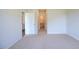 Well-lit bedroom featuring carpet and access to bathroom at 1117 Middlecrest Dr, Rocky Mount, NC 27804