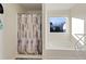 Bathroom with shower, tub, and a window offering natural light at 1134 Aster Way, Burlington, NC 27215