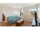 Bright bonus room with wood floors, comfy couch and large windows at 1134 Aster Way, Burlington, NC 27215