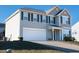 Two-story house with gray siding, white garage door, and landscaping at 1134 Aster Way, Burlington, NC 27215