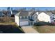 Two-story house with gray siding, a white door, and a two-car garage at 1134 Aster Way, Burlington, NC 27215