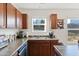 Kitchen features wood cabinets, a double sink, and ample counter space at 1134 Aster Way, Burlington, NC 27215