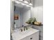 Bathroom boasts a marble vanity and large mirror at 1535 Caraleigh Mills Ct # 221, Raleigh, NC 27603