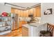 Modern kitchen with stainless steel appliances and wood cabinets at 1535 Caraleigh Mills Ct # 221, Raleigh, NC 27603