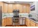 Modern kitchen with stainless steel appliances and light wood cabinets at 1535 Caraleigh Mills Ct # 221, Raleigh, NC 27603