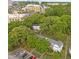 Aerial view of a townhouse complex surrounded by mature trees and lush landscaping at 1621 Sutton Dr, Raleigh, NC 27605