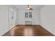Bright bedroom with hardwood floors and access to the hallway at 1621 Sutton Dr, Raleigh, NC 27605