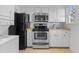 Updated kitchen with stainless steel appliances and a view of the backyard at 1621 Sutton Dr, Raleigh, NC 27605