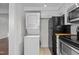 Convenient stackable washer and dryer in the kitchen area at 1621 Sutton Dr, Raleigh, NC 27605