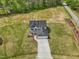 Aerial view of the beautiful home with a long driveway and landscaped yard at 18 Hewitt Woods Dr, Clayton, NC 27527