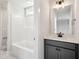 Bright bathroom featuring white countertop, gray vanity, and bath at 18 Hewitt Woods Dr, Clayton, NC 27527