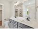 Bathroom with double sink vanity, large mirror, and walk-in shower at 18 Hewitt Woods Dr, Clayton, NC 27527