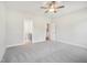 Spacious bedroom features a ceiling fan, grey carpet, and access to a bathroom at 18 Hewitt Woods Dr, Clayton, NC 27527