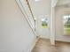 Bright entryway featuring wood flooring, a staircase with white risers and a partial view to the outside at 18 Hewitt Woods Dr, Clayton, NC 27527