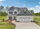 Two-story home with manicured lawn, two-car garage, and inviting curb appeal at 18 Hewitt Woods Dr, Clayton, NC 27527