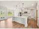 Open kitchen featuring a center island with quartz countertop, pendant lights, and stainless steel appliances at 18 Hewitt Woods Dr, Clayton, NC 27527