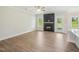 Open-concept living room with fireplace, windows, access to the backyard, and seamless flow to kitchen at 18 Hewitt Woods Dr, Clayton, NC 27527