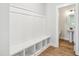 Bright mudroom with built-in bench and storage cubbies, leading to a half bathroom with modern fixtures at 18 Hewitt Woods Dr, Clayton, NC 27527