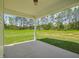 Covered patio with a view of the expansive backyard and lush trees at 18 Hewitt Woods Dr, Clayton, NC 27527