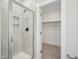 Modern shower featuring bright tiles, shower niche, and glass door at 18 Hewitt Woods Dr, Clayton, NC 27527