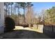 Private backyard with wooden fence and trees at 221 Georgetowne Dr, Clayton, NC 27520