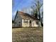 View of the side and front of the home with a brick chimney and red shutters at 2324 Lonnie Cir, Hillsborough, NC 27278
