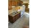 Cozy kitchen featuring wood panel walls, updated cabinets, and white appliances at 2324 Lonnie Cir, Hillsborough, NC 27278