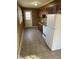 Functional kitchen with wood panel walls, white appliances, and tiled floor at 2324 Lonnie Cir, Hillsborough, NC 27278
