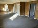 Bright living room featuring paneled walls, plush carpeting, and sunlit spaces at 2324 Lonnie Cir, Hillsborough, NC 27278