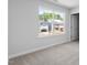 Bedroom with carpeted floor and a window overlooking the neighborhood at 257 North Maple Walk Dr # 218, Garner, NC 27529