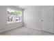 A light-filled bedroom offers a view of the home's surroundings and a neutral color palette at 257 North Maple Walk Dr # 218, Garner, NC 27529