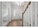 Bright foyer featuring hardwood floors, a white front door with sidelights, chandelier and glass French doors at 257 North Maple Walk Dr # 218, Garner, NC 27529