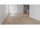 Hallway with hardwood floors and access to a bedroom with double doors at 257 North Maple Walk Dr # 218, Garner, NC 27529