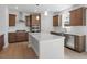 Gourmet kitchen featuring white countertops, dark wood cabinets, stainless steel appliances, and a stylish backsplash at 257 North Maple Walk Dr # 218, Garner, NC 27529