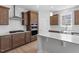 Kitchen with stainless steel appliances, white backsplash, and wood cabinets at 257 North Maple Walk Dr # 218, Garner, NC 27529