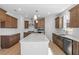 Modern kitchen with stainless steel appliances, kitchen island, and wood cabinets at 257 North Maple Walk Dr # 218, Garner, NC 27529