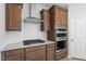 Kitchen with stainless steel appliances, white backsplash, and wood cabinets at 257 North Maple Walk Dr # 218, Garner, NC 27529