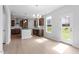 Modern kitchen with hardwood floors, stainless steel appliances, white cabinets, and an island with bar seating at 257 North Maple Walk Dr # 218, Garner, NC 27529