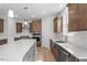 Open kitchen with stainless steel appliances, kitchen island, and wood cabinets at 257 North Maple Walk Dr # 218, Garner, NC 27529