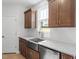 Kitchen with stainless steel sink, white backsplash, and wood cabinets at 257 North Maple Walk Dr # 218, Garner, NC 27529