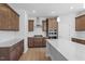 Open kitchen with stainless steel appliances, kitchen island, and wood cabinets at 257 North Maple Walk Dr # 218, Garner, NC 27529