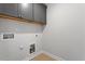 Practical laundry room with overhead cabinets and utility connections at 257 North Maple Walk Dr # 218, Garner, NC 27529