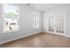 Bright living room featuring hardwood floors, large windows and glass french doors, offering natural light at 257 North Maple Walk Dr # 218, Garner, NC 27529