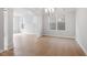 Spacious living room featuring hardwood floors, white pillars, and large windows providing plenty of natural light at 257 North Maple Walk Dr # 218, Garner, NC 27529