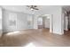 Bright living room with hardwood floors, ceiling fan, and arched doorway to the dining area at 257 North Maple Walk Dr # 218, Garner, NC 27529